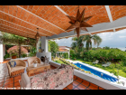 04----Main-House-Lanai-with-Fireplace-Overlooks-the-Heated-Pool,-Organic-Gardens-and-Lake