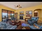 18 - Living Room has a Fireplace for Cooler Evenings and Embraces the South Terrace and Lake Views